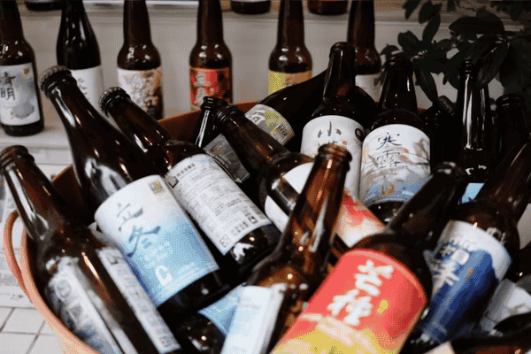 Alt text suggestion Assorted craft beer bottles with colorful labels.