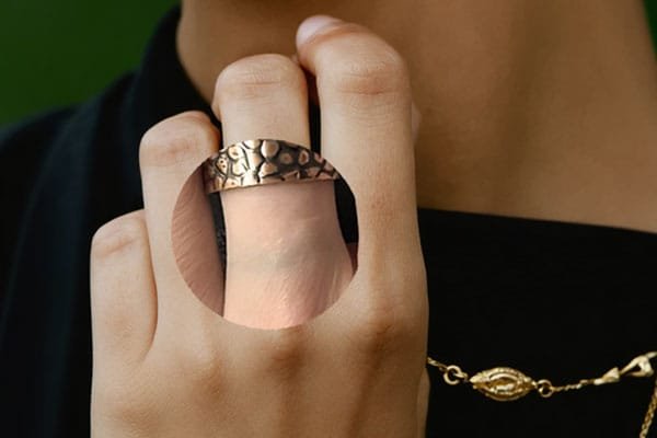 Hand Wearing Jewelry with Green Stain