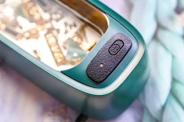 Jeweler Cleaning Jewelry with Ultrasonic Machine