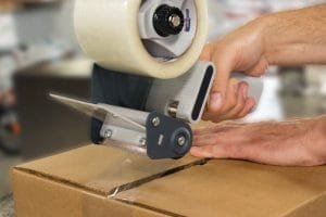 Hand Applying Packing Tape to Box