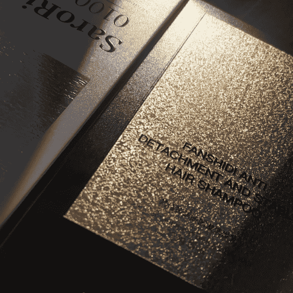 Luxury gold foil packaging with embossed text.