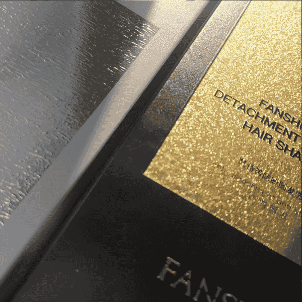 Luxury black and gold packaging with embossed details.