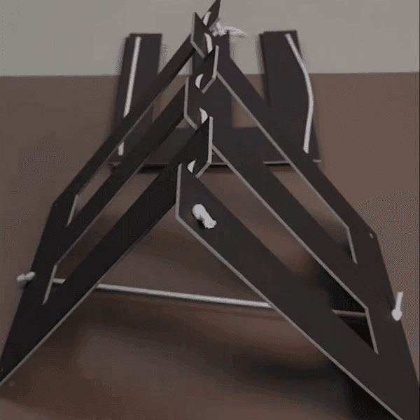 Black geometric cardboard structure with white edges