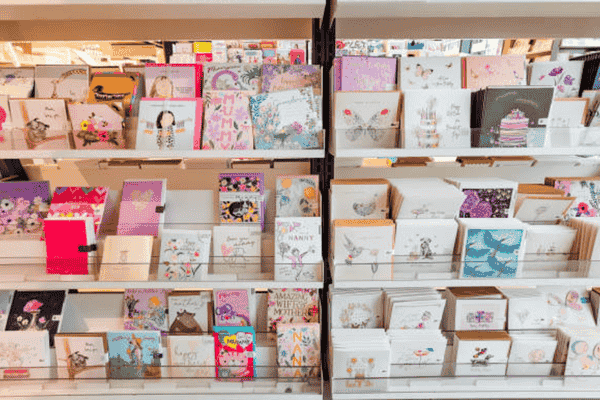 Colorful greeting cards displayed on shelves.