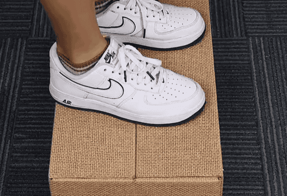 Durable cardboard shoe box supporting weight.