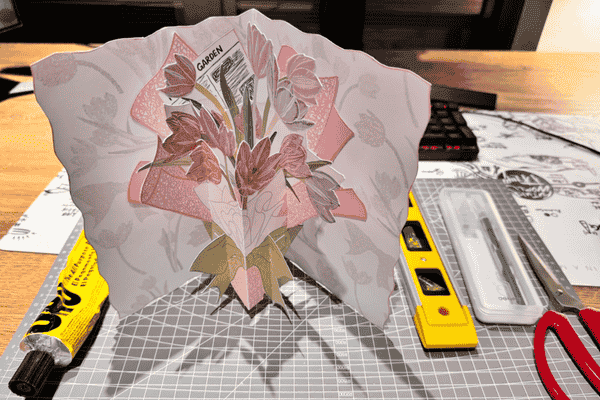 Intricate pop-up flower card in progress.