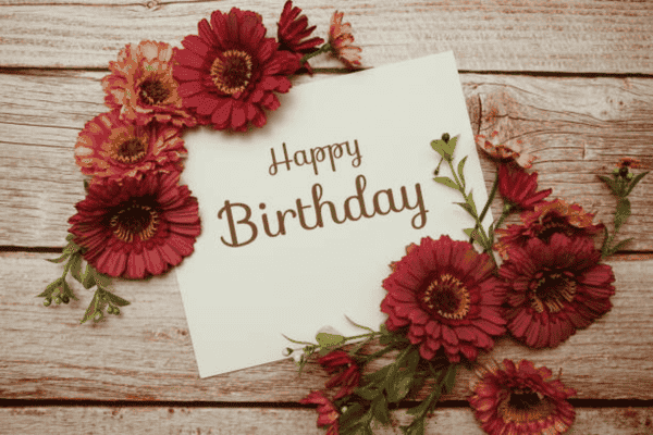 Rustic birthday card with red flowers.
