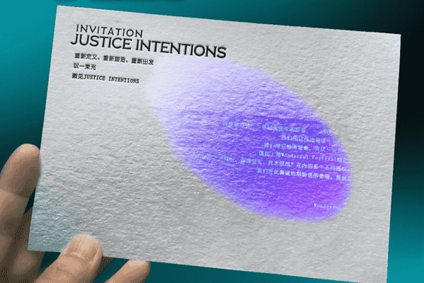 UV light revealing hidden design details on a printed card.