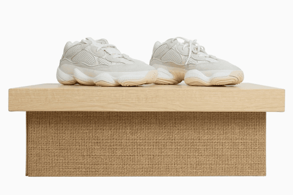 Textured cardboard shoe box with sneakers.