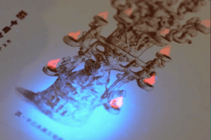 UV light revealing hidden design details on a printed card.