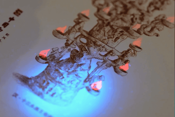 UV light revealing hidden design details on a printed card.