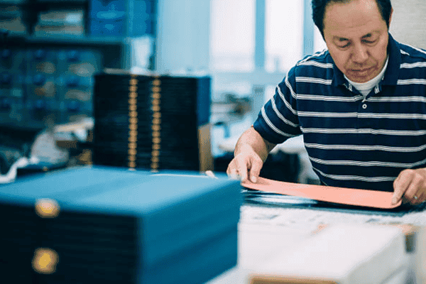 Factory engineer inspecting printed gift box samples