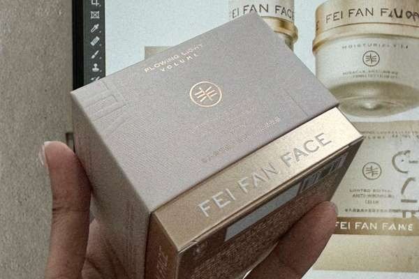 Alt: Cosmetic display box dieline and samples Factory design desk with cosmetic box dieline and product samples