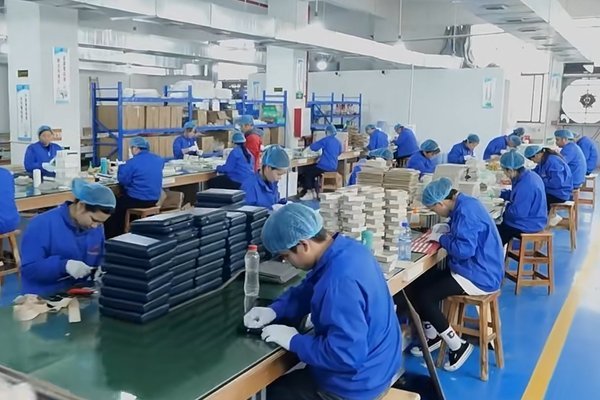 Use image: packaging factory desk with jewelry box sample, dieline proof, material swatches, and QC notes Factory sample checking for luxury jewelry boxes