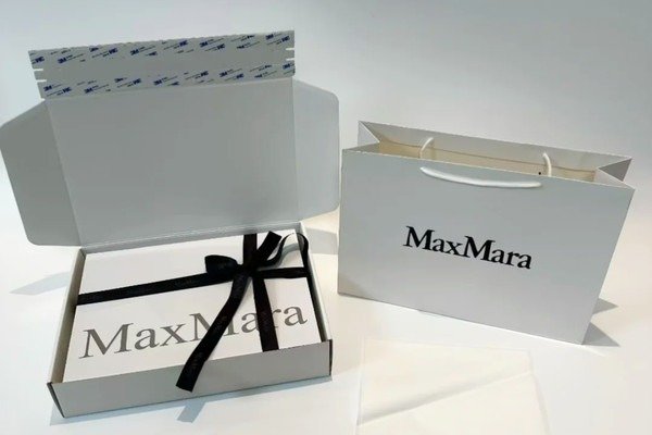 Foldable rigid apparel box shown flat and assembled with clothing inside